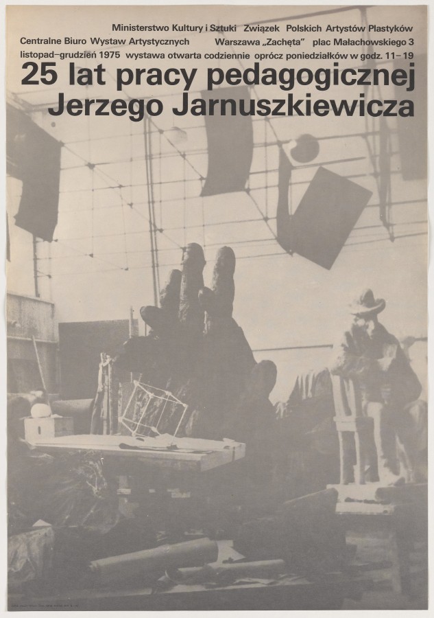 Całą przestrzeń plakatu zajmuje szare i zamglone zdjęcie pracowni rzeźbiarskiej z rzeźbami, rulonami papieru, stołem, kawałkami materiału.